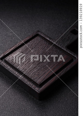 An empty wooden cutting board, kitchen utensils for food preparation. An empty cutting board 139218919