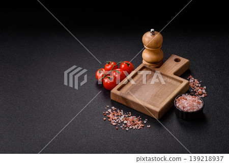 An empty wooden cutting board, kitchen utensils for food preparation. An empty cutting board An empty wooden cutting board, kitchen utensils for food preparation. An empty cutting board 139218937