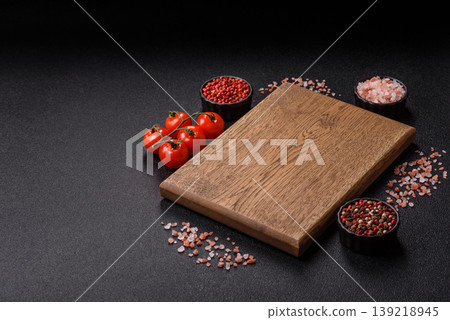 An empty wooden cutting board, kitchen utensils for food preparation. An empty cutting board An empty wooden cutting board, kitchen utensils for food preparation. An empty cutting board 139218945