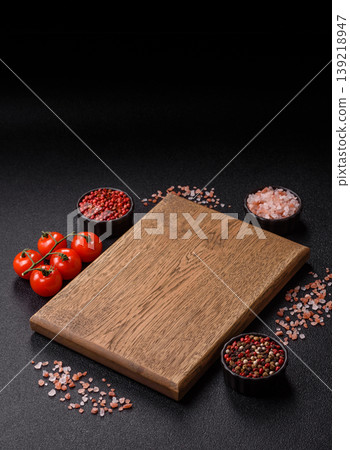 An empty wooden cutting board, kitchen utensils for food preparation. An empty cutting board An empty wooden cutting board, kitchen utensils for food preparation. An empty cutting board 139218947
