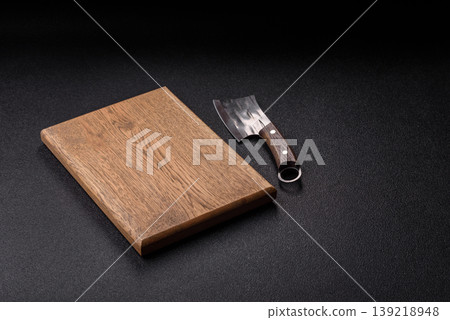 An empty wooden cutting board, kitchen utensils for food preparation. An empty cutting board An empty wooden cutting board, kitchen utensils for food preparation. An empty cutting board 139218948