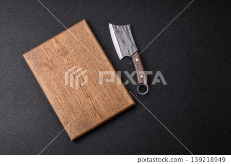 An empty wooden cutting board, kitchen utensils for food preparation. An empty cutting board An empty wooden cutting board, kitchen utensils for food preparation. An empty cutting board 139218949