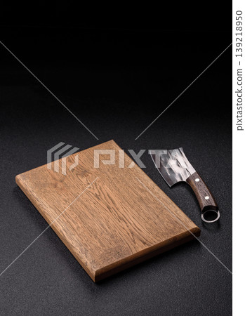 An empty wooden cutting board, kitchen utensils for food preparation. An empty cutting board An empty wooden cutting board, kitchen utensils for food preparation. An empty cutting board 139218950