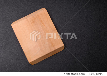 An empty wooden cutting board, kitchen utensils for food preparation. An empty cutting board An empty wooden cutting board, kitchen utensils for food preparation. An empty cutting board 139218959