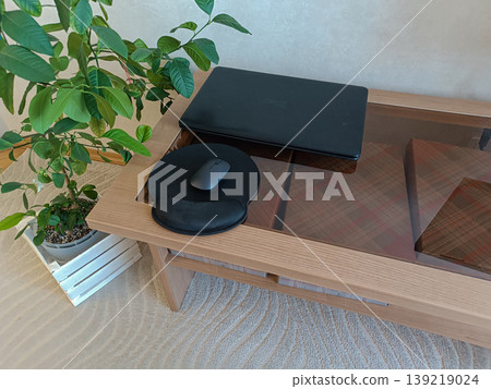 Cozy Remote Workspace with Laptop on Wooden Table Cozy Remote Workspace with Laptop on Wooden Table 139219024
