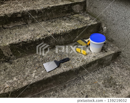 Paint Scraper, Roller, and Bucket on Concrete Steps 139219032