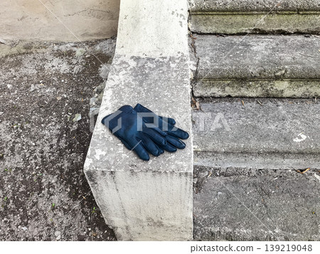 Black leather gloves on concrete ledge Black leather gloves on concrete ledge 139219048