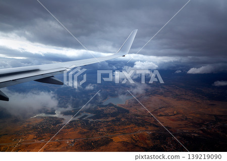 Aircraft wing in a cloudy stormy clouds sky Aircraft wing in a cloudy stormy clouds sky 139219090