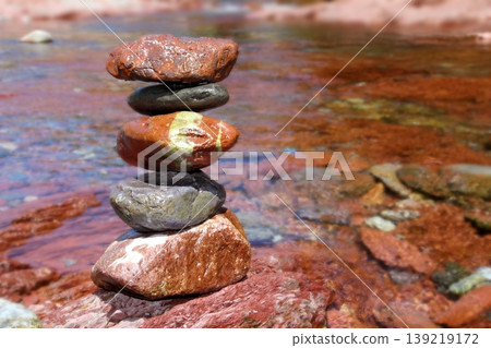 Rolling stones stacked red rodeno limestone in river Rolling stones stacked red rodeno limestone in river 139219172
