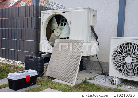 Outdoor heat pump unit with removed panel during service Outdoor heat pump unit with removed panel during service 139219329
