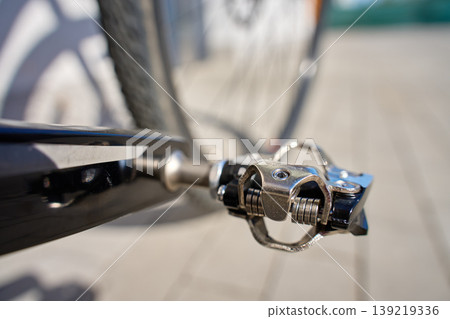 Close up of clipless bicycle pedal on bike crank arm Close up of clipless bicycle pedal on bike crank arm 139219336
