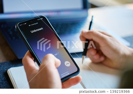 Unknown incoming call on smartphone during working at desk 139219366