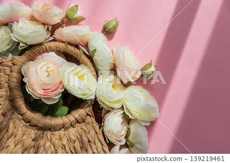Straw Handbag with Ranunculus Flowers on Pink Background Straw Handbag with Ranunculus Flowers on Pink Background 139219461
