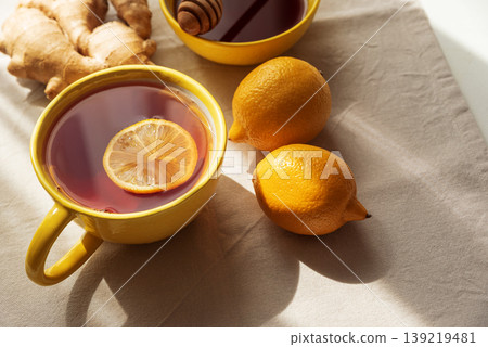 Flat Lay with Lemon Tea, Ginger and Honey on Light Table 139219481