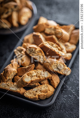 Grissini. Almond Biscotti Cookies on a Plate - Crunchy Italian Biscotti Dessert for Coffee or Tea Grissini. Almond Biscotti Cookies on a Plate - Crunchy Italian Biscotti Dessert for Coffee or Tea 139219596