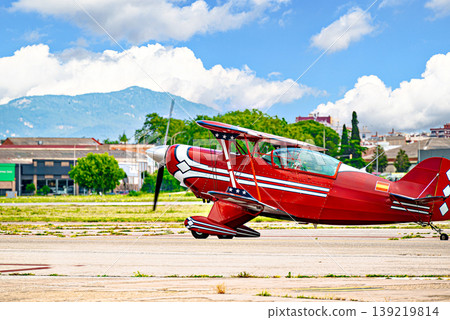 Airplane, red-lit aerobatic biplane. Air show. Airplane, red-lit aerobatic biplane. Air show. 139219814