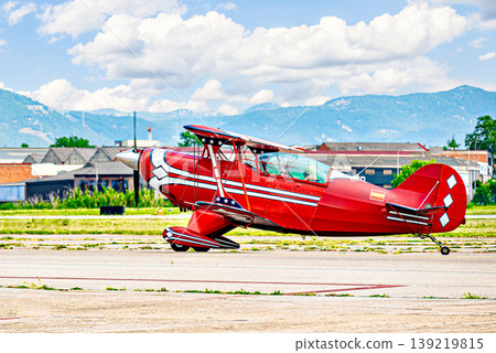 Airplane, red-lit aerobatic biplane. Air show. Airplane, red-lit aerobatic biplane. Air show. 139219815