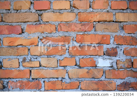 Old red brick wall texture. Background of a red brick wall, brick wall background. Stack of old, weathered bricks. 139220034