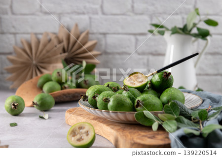 Fresh green feijoa fruit on a white plate Fresh green feijoa fruit on a white plate 139220514