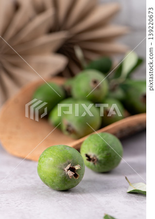 Fresh green feijoa fruit on a neutral surface Fresh green feijoa fruit on a neutral surface 139220673