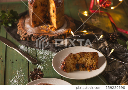 Served Slice of Panettone with Festive Decor on Green Wood Served Slice of Panettone with Festive Decor on Green Wood 139220698