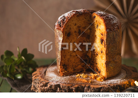 Half-Sliced Panettone Cake with Chocolate and Festive Greenery Half-Sliced Panettone Cake with Chocolate and Festive Greenery 139220711