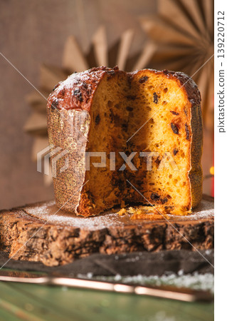 Sliced Italian Panettone with Chocolate Chips on a Dark Wood Slab Sliced Italian Panettone with Chocolate Chips on a Dark Wood Slab 139220712