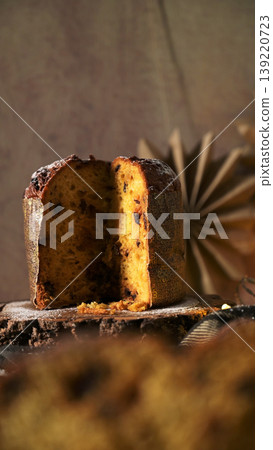 Vertical Close-up of Sliced Traditional Italian Panettone Christmas Bread on a Rustic Wooden Block Vertical Close-up of Sliced Traditional Italian Panettone Christmas Bread on a Rustic Wooden Block 139220723
