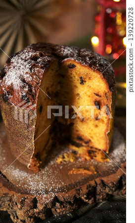 Close-up Vertical Image of Sliced Panettone with Powdered Sugar and Bokeh Close-up Vertical Image of Sliced Panettone with Powdered Sugar and Bokeh 139220728