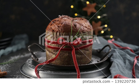 Traditional Italian Panettone with Red Velvet Ribbon on Vintage Metal Tray Traditional Italian Panettone with Red Velvet Ribbon on Vintage Metal Tray 139220736