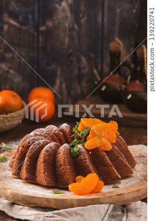 Mandarin Orange Bundt Cake with Powdered Sugar on a Rustic Wooden Table Mandarin Orange Bundt Cake with Powdered Sugar on a Rustic Wooden Table 139220741