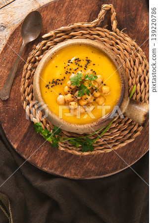 Creamy Chickpea and Pumpkin Soup Topped with Black Sesame and Parsley Creamy Chickpea and Pumpkin Soup Topped with Black Sesame and Parsley 139220786