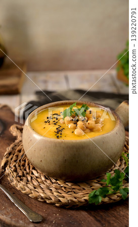 Creamy Chickpea and Vegetable Soup Garnished with Black Sesame Seeds and Fresh Parsley 139220791
