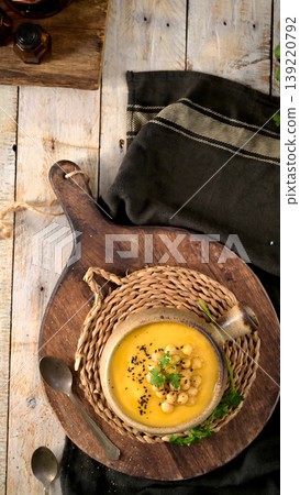 Creamy Chickpea Soup in a Rustic Bowl with Toppings on a Wooden Background 139220792