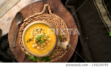 Creamy Butternut Squash Soup Topped with Chickpeas and Nigella Seeds 139220793