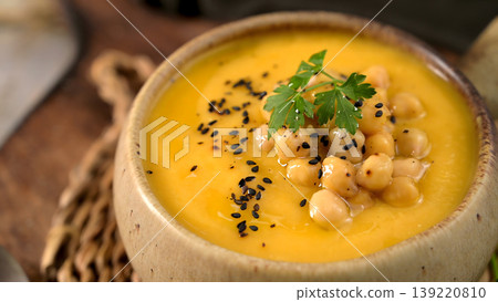 Creamy Butternut Squash Soup Topped with Roasted Chickpeas and Black Sesame Seeds 139220810
