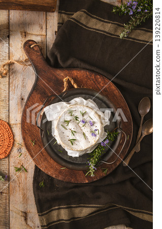Baked Camembert Cheese with Fresh Rosemary and Purple Flowers on Rustic Wooden Board Baked Camembert Cheese with Fresh Rosemary and Purple Flowers on Rustic Wooden Board 139220814