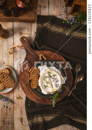 Baked Camembert Cheese with Rosemary and Grilled Bread on Rustic Wooden Board Baked Camembert Cheese with Rosemary and Grilled Bread on Rustic Wooden Board 139220815