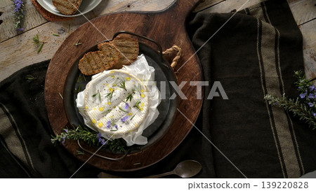 Baked Camembert Cheese with Rosemary and Grilled Bread on Rustic Wooden Board Baked Camembert Cheese with Rosemary and Grilled Bread on Rustic Wooden Board 139220828