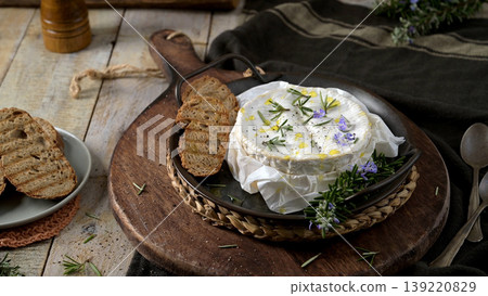 Baked Camembert Cheese with Rosemary and Toasted Bread on Rustic Wooden Board Baked Camembert Cheese with Rosemary and Toasted Bread on Rustic Wooden Board 139220829