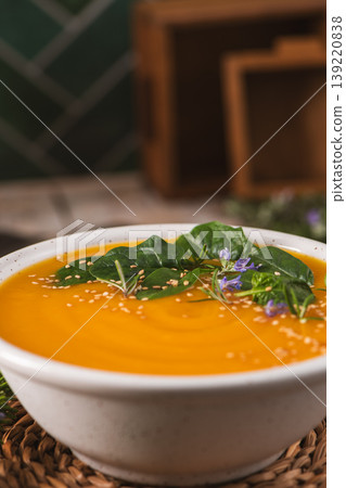 Creamy Pumpkin Soup with Fresh Spinach Garnish and Toasted Sesame Seeds 139220838