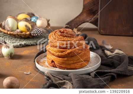 Artisan Easter Cinnamon Roll with Pastel Eggs and Feathers 139220916