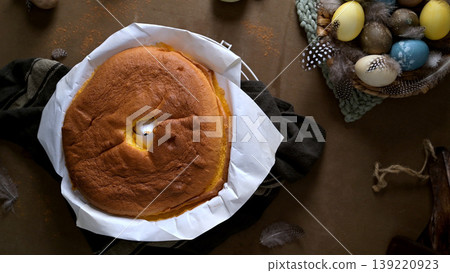 Freshly Baked Sponge Cake with Easter Eggs and Feathers in a Rustic Table Setting Freshly Baked Sponge Cake with Easter Eggs and Feathers in a Rustic Table Setting 139220923