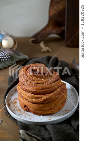 Vertical Portrait of Gourmet Cinnamon Bun with Easter Accents Vertical Portrait of Gourmet Cinnamon Bun with Easter Accents 139220928