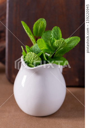 Fresh Mint Leaves in a Small White Ceramic Pitcher 139220945