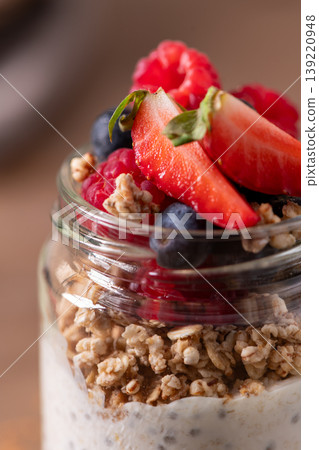 Healthy Chia Pudding and Granola Parfait Topped with Fresh Berries 139220948