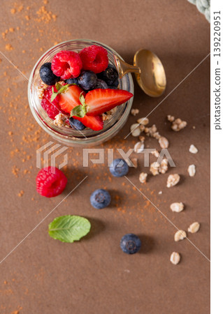 Healthy Berry Parfait with Fresh Raspberries and Strawberries in a Glass Jar 139220951