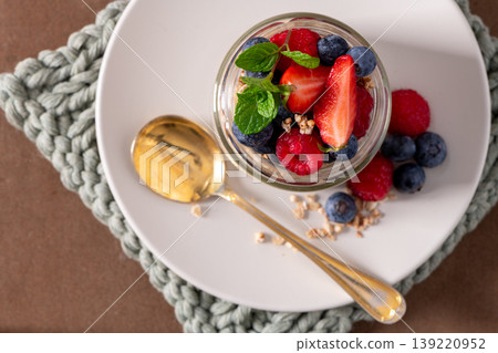 Fresh Fruit Parfait with Berries and Mint in a Glass Jar on a Plate Fresh Fruit Parfait with Berries and Mint in a Glass Jar on a Plate 139220952