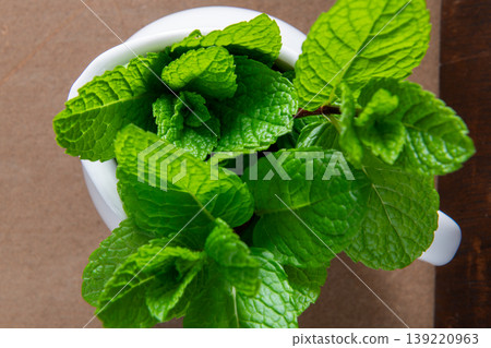Fresh Green Mint Leaves in a White Ceramic Pitcher Fresh Green Mint Leaves in a White Ceramic Pitcher 139220963
