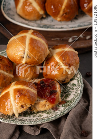 Stacked Hot Cross Buns on Vintage Plate with Fruit Jam and Raisins 139221096